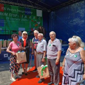 Festyn integracyjny Barierom stop w Lisówkach. Grupa seniorów ze Swarzędza pozuje do zdjęcia z członkinią zarządu Powiatu Poznańskiego Elżbietą Nawrocką.